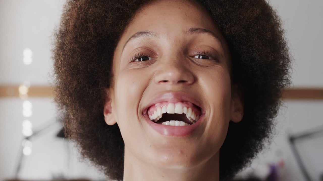 Portrait of happy biracial female worker in workshop in jewellery studio in slow motion