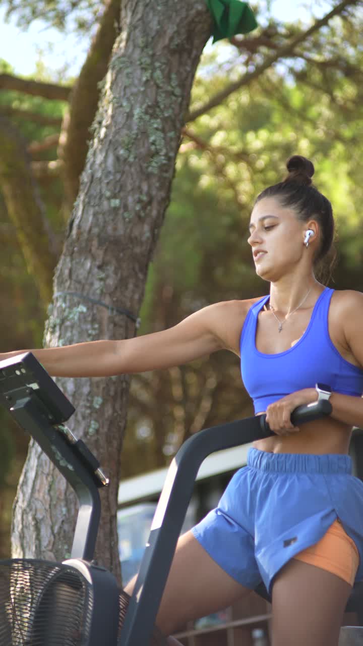 Woman exercising on stationary bike outdoors
