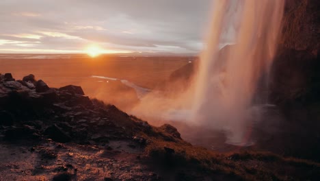 Slow motion shot of Seljalandsfoss at sunset, a famous waterfall in Iceland
