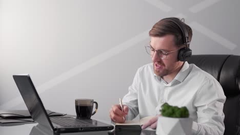 a man wearing a laptop goes through online training