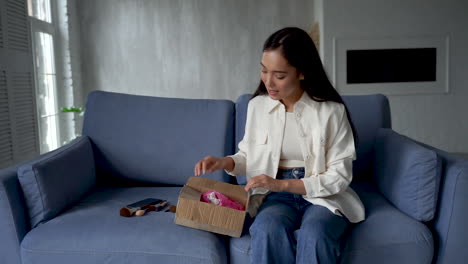 female influencer doing unboxing, showing new make up products