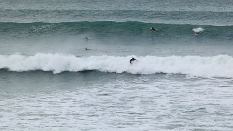 Surfer-with-helmet-doing-Turn-On-Blue-Wave-and-doing-re-entry