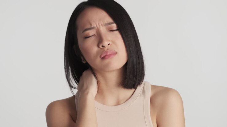 Asian woman feeling tired on camera.