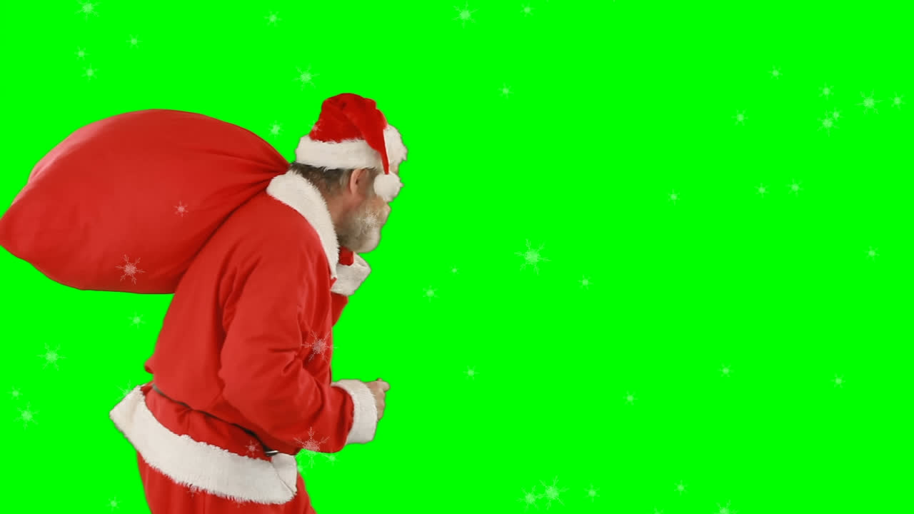 animación de santa claus con el dedo en los labios llevando el saco sobre el fondo de la pantalla verde