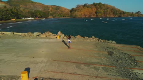 a model enjoying beach views in a fishing village on the north western coast of tobago