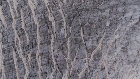 close-up view of textured rock face with vertical striations