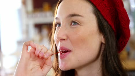 beautiful woman eating a cherry