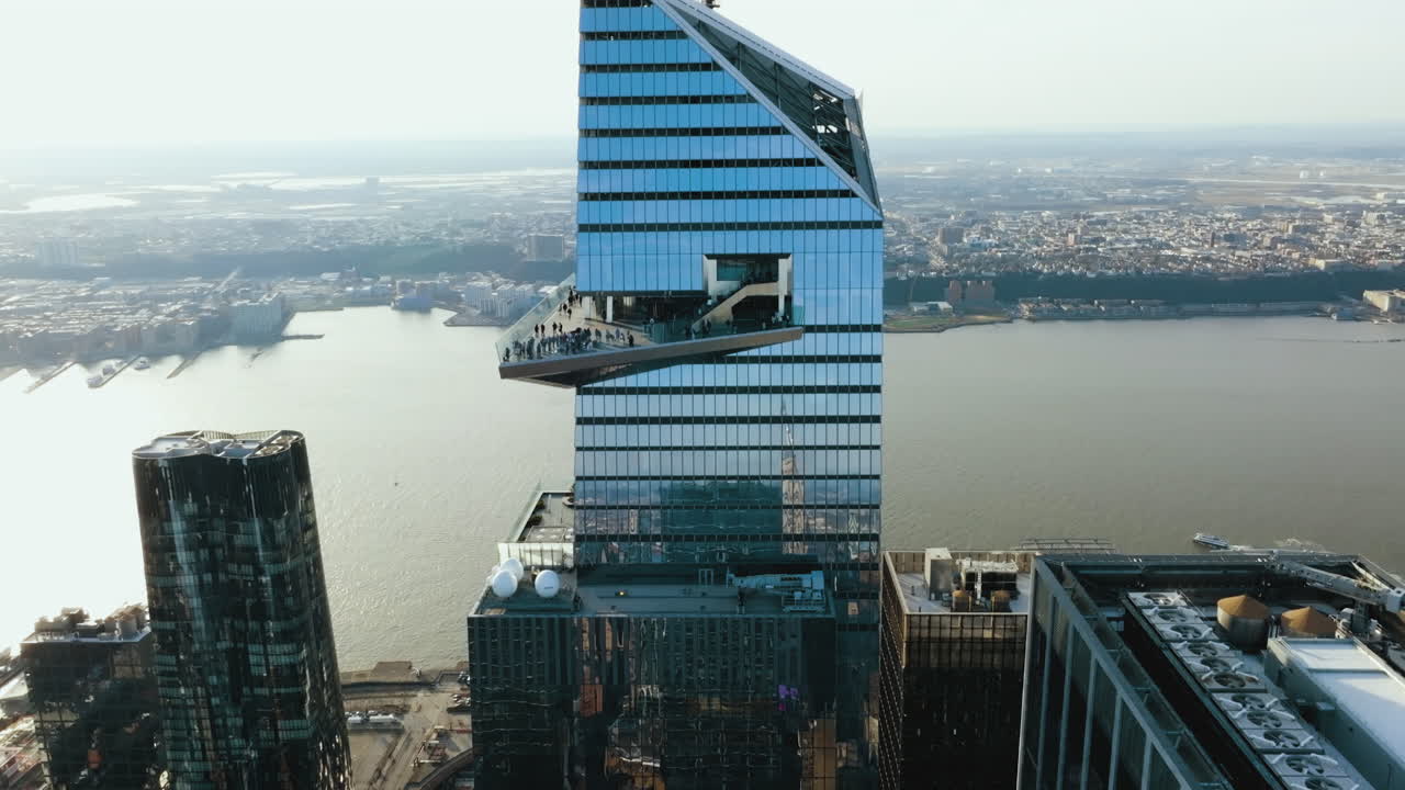 People on the Edge sky deck of 30 Hudson Yards high-rise in NY - Ascending, aerial view