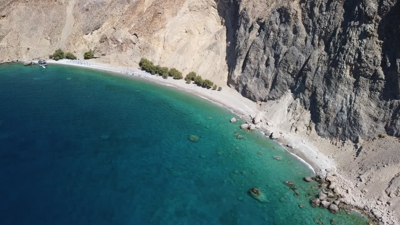 Orbiting Drone Shot of Sweet Water beach with Huge Cliff, In Crete Greece