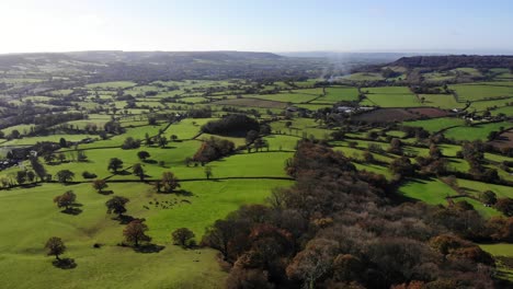 aerial backwards shot overlooking the otter valley and beautiful devon countryside in england