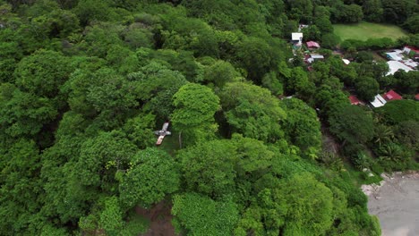 aerial view of abandoned plane in the hills near the coastline at samara beach, costa rica