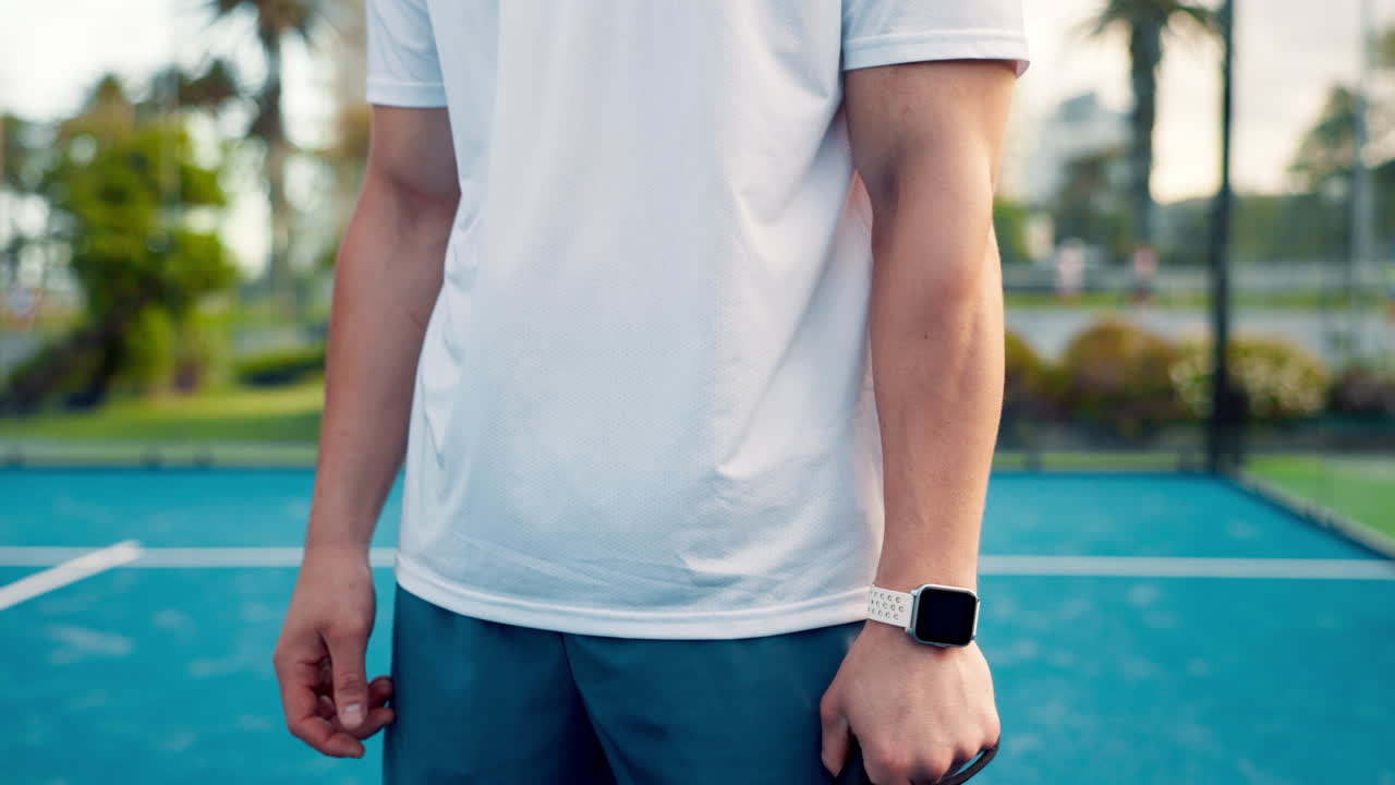 Padel Player Adjusting Smartwatch on Court