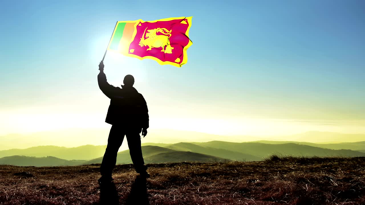 Uomo vincitore in silhouette di successo che sventola la bandiera dello Sri Lanka sulla cima della montagna, sfondo Cinemagraph LOOP