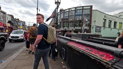 man walking through busy camden town street