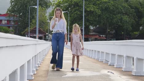 mother and daughter on a bridge