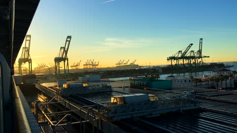 a shipyard in california, a lot of cranes and crates