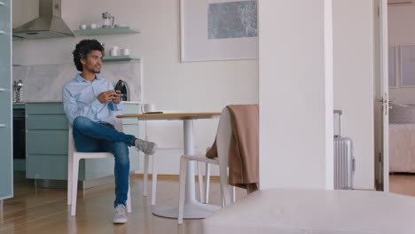 young man using smartphone texting social media messages browsing online enjoying mobile communication at home