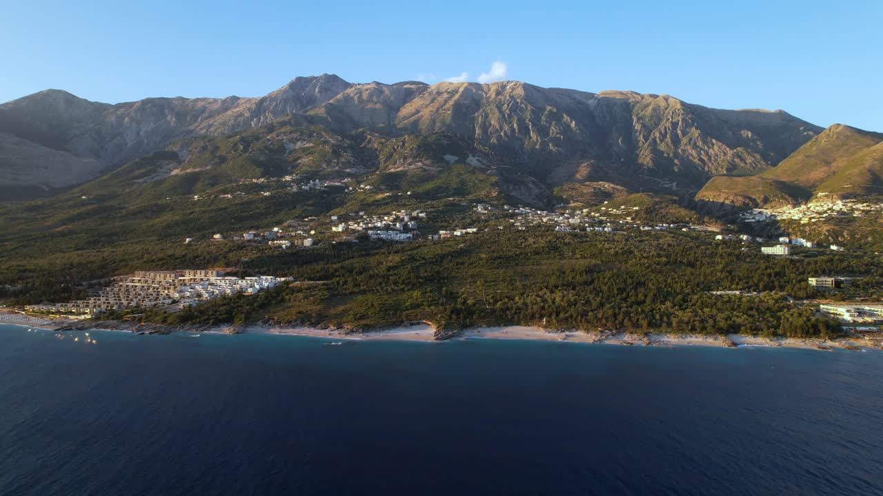 Riviera coastline with unspoiled beaches, blue clean sea water, resorts and mountains background in Albania