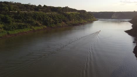 aerial view of boat cruising on iguazu river meeting rio parana and triple border between argentina,brazil and paraguay