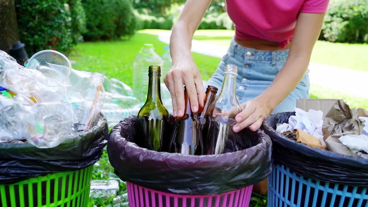 Woman Recycling Glass and Plastic Bottles