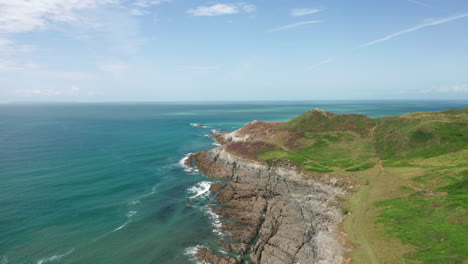 aerial fly away from a coastal headland in north devon on a summer’s day