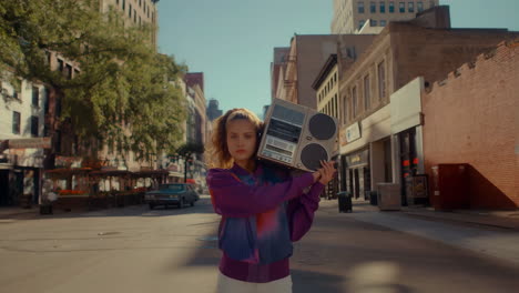 young woman with boombox on city street