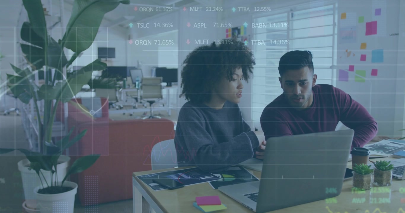 Woman speaking gesturing, pair leaning pointing laptop while reviewing finance charts across screen