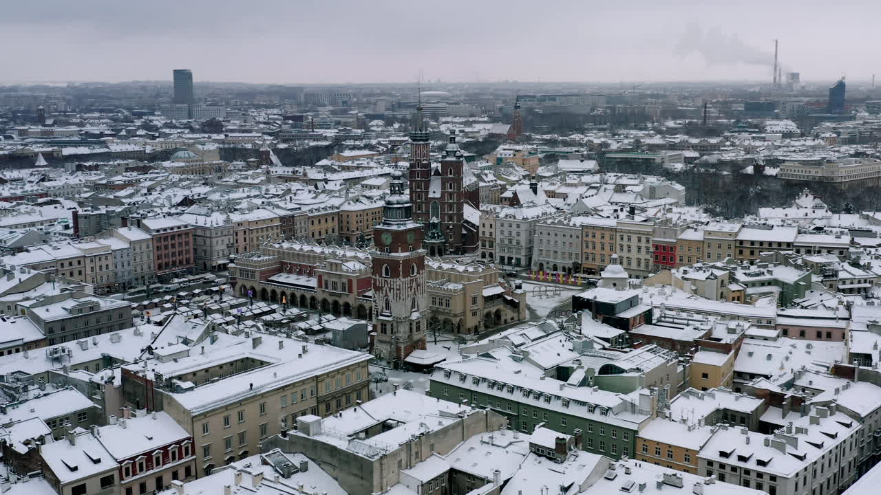 Snow-covered Old Town (Krakow city center - Main Square, Sukiennice - Cloth Hall and Town Hall) at cloudy morning, Krakow, Poland