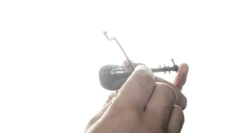 Trying-to-play-the-world's-tiniest-violin:-a-toy-symbolizing-irony,-mocks-others'-complaints-with-its-tiny-tune,-gently-highlighting-life's-absurdities