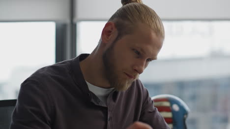 Thoughtful-student-pondering-home-portrait.-Focused-man-holding-pen-thinking