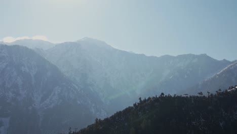 Aerial-shot-of-snowy-mountains-in-Neelum-Valley-with-sunrise