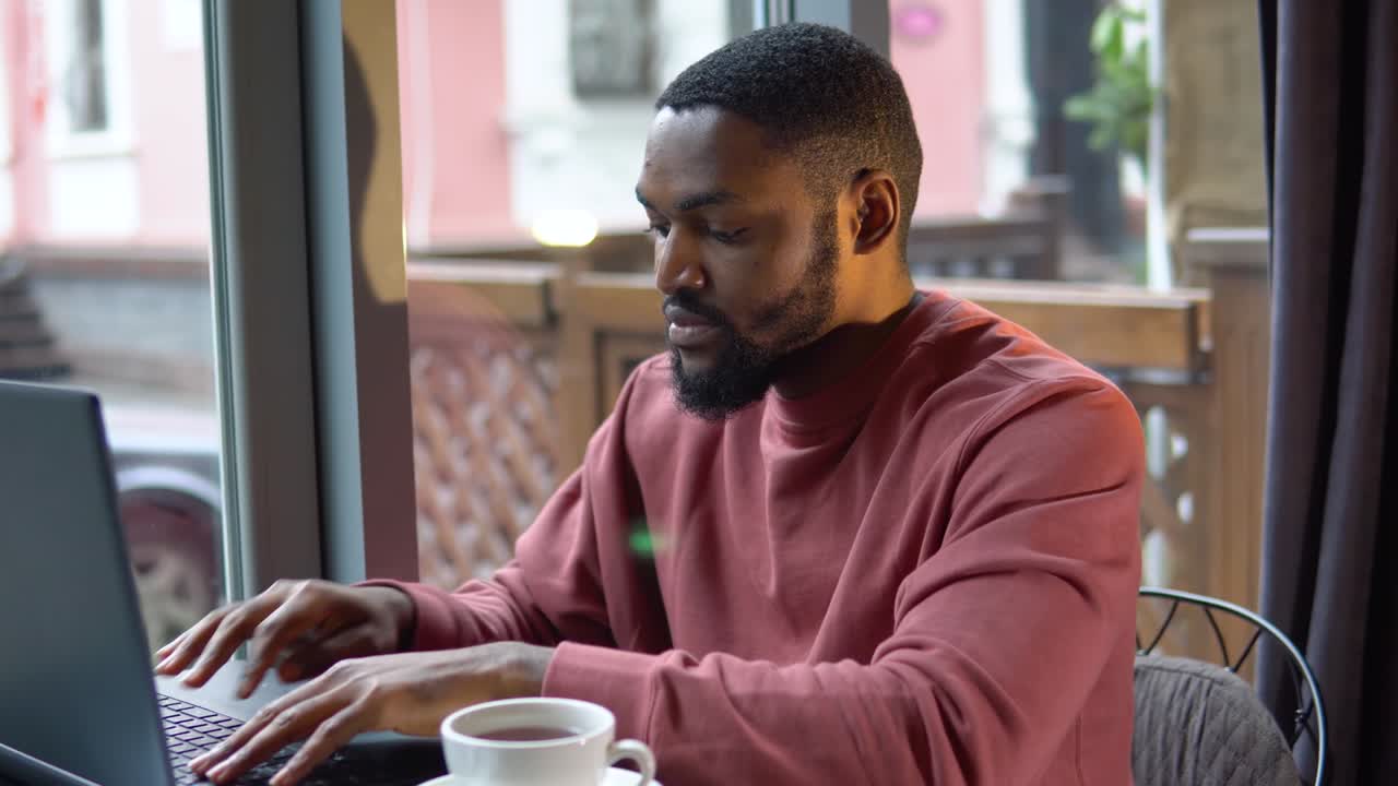 Man working with the laptop in the restaurant