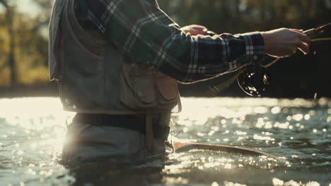 man fly fishing in a river