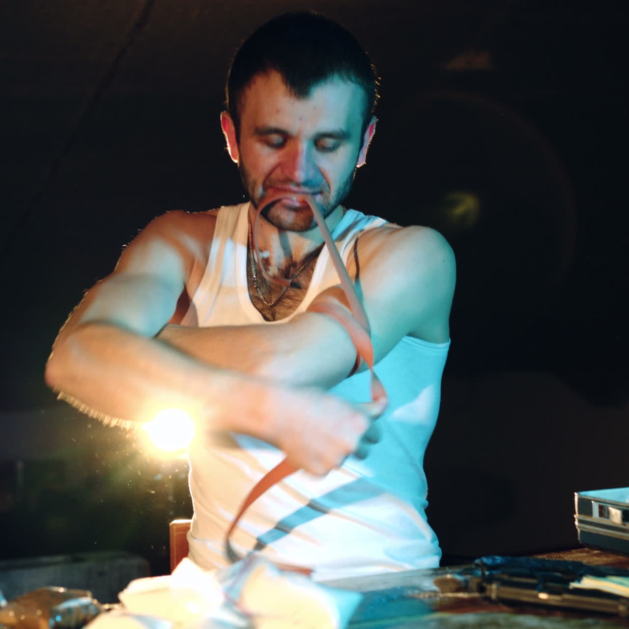 Male drug addict holds a tourniquet, preparing for injecting drugs. Drugs and the concept of crime.
