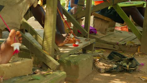 shot of african children weaving fabrics with the movement of the feet