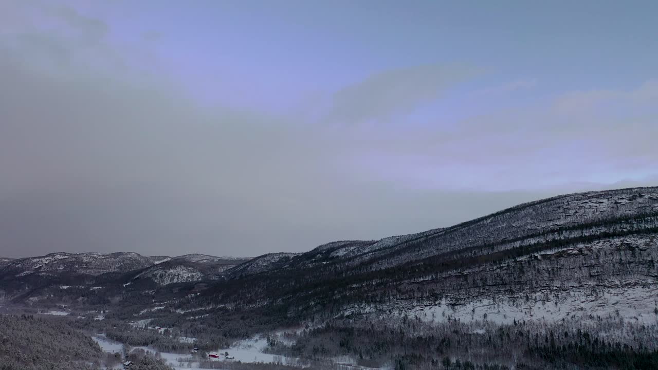 Cinematic aerial views capture the frozen beauty of northern Norway’s Arctic Circle, featuring snow-covered Saltfjellet mountains and pristine winter landscapes in 4K.