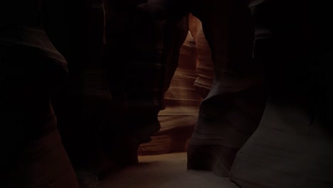 tilt down shot revealing a beautiful natural colorful sandstone slot canyon in arizona with textures and abstract shapes and the sun shining above on a warm sunny spring evening