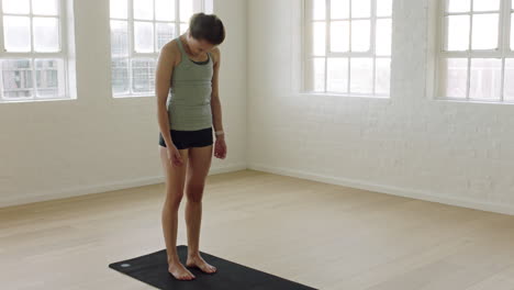 healthy yoga woman stretching flexible body enjoying fitness lifestyle practicing poses in workout studio training on exercise mat at sunrise