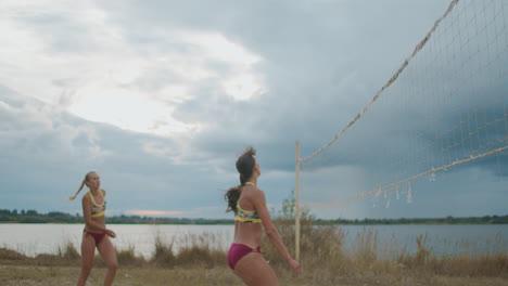 active-entertainment-of-young-sportswomen-at-summer-vacation-ladies-are-playing-beach-volleyball-professional-teams-dressed-sporty-bikini