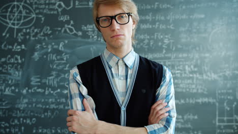 student in front of a blackboard full of equations