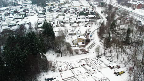 Snow-covered-residential-area-in-Kviberg,-Gothenburg-with-houses-and-roads,-aerial-view