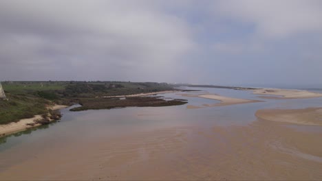 Aerial-view-of-low-tide-lagoon-of-the-Ria-Formosa,-Cacela-Velha,-Portugal