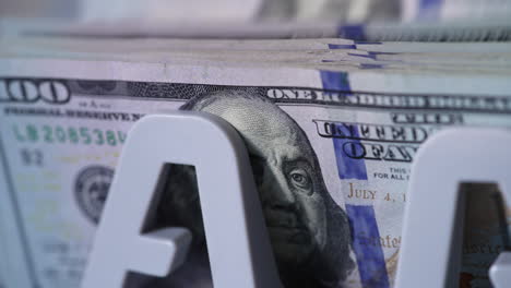 benjamin franklin portrait on the dollar bills. cash counting machine counts american currency bills. close up.