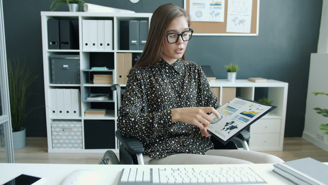 Businesswoman in Wheelchair Reviewing Documents