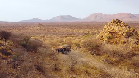 aerial of tourists enjoying a moment on a safari jeep at the vast and beautiful erindi game preserve namibia