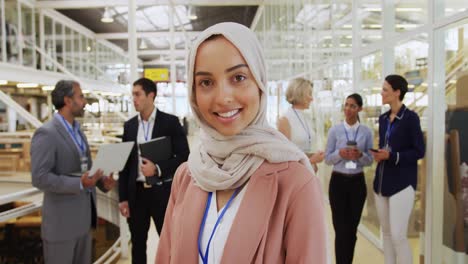 businesswoman holding smartphone in a conference foyer