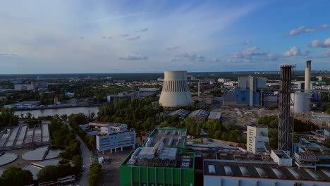 waste incineration plant, waste to new energy sources, cooling tower polluting the atmosphere and contributing to climate change. best aerial view flight panorama orbit drone