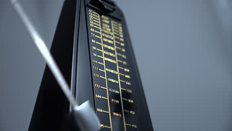 Close-up-shot-of-a-vintage-metronome-that-beats-rhythm-on-grey-background