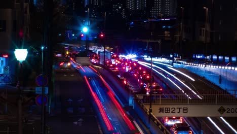 a night timelapse of the traffic jam at the city street in tokyo long shot