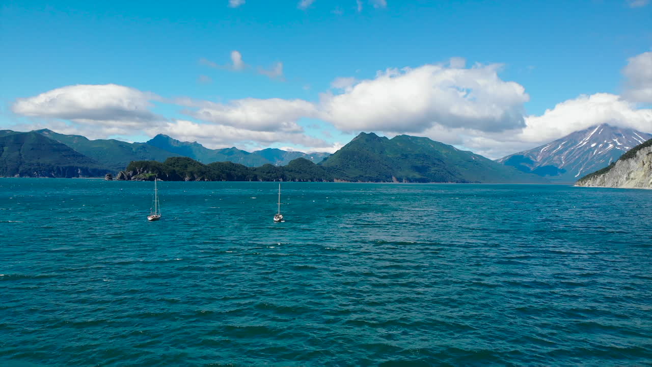Scenic Seascape with Mountains and Sailboats